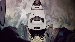 The space shuttle approaches a space station in orbit.  Aged video to simulate NASA archival footage.  Composited imagery courtesy of NASA.