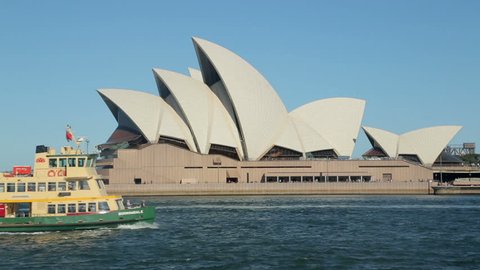 SYDNEY, AUSTRALIA - FEBRUARY 02, 2014: Sydney ferry passes opera house.  The Opera House opened in October 1973 and was designed by Jorn Utzon.

