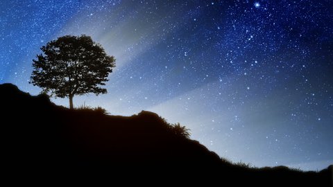 Stars behind silhouette of a hill