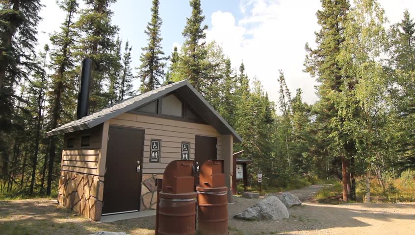Bathroom Tree Alaska Lake. Campsite bathrooms in forrest clearing.