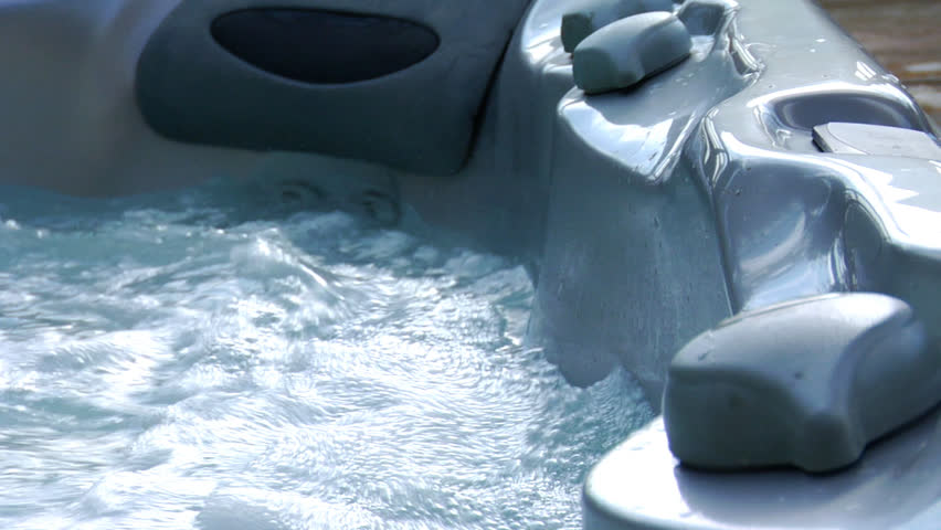 This is a man's foot testing the waters of his new hot tub. Shot in slow motion