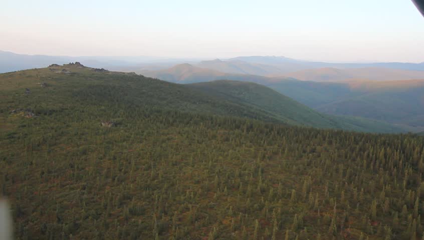 Alaska Rocks Hills. Expansive greenery and hills in Alaska, featuring rock formations and trees.