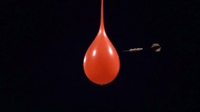 Dart pops water balloon in super slow motion. Shot with Phantom camera at 6900 frames per second. - Powered by Shutterstock - Get 15% off with code: PIKWIZARD15