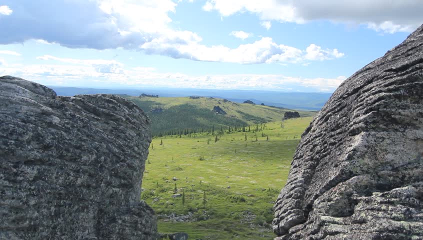 Waterfall Alaska Forrest Spring. Wide view of Alaskan landscape from cliff rocks.