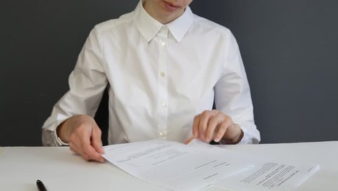Young businesswoman filling in a form