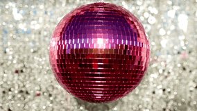 Funky pink mirror ball spinning with patterns of light - Powered by Shutterstock - Get 15% off with code: PIKWIZARD15