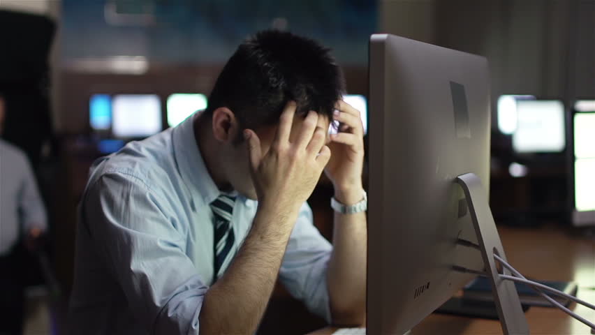 Frustrated businessman sitting in front of computer monitor in office | Shutterstock HD Video #5917724