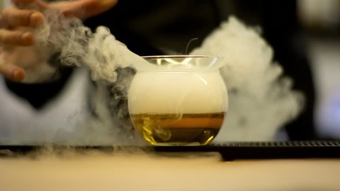Cocktail waiter making drink with dry ice 