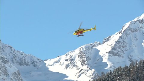 Helicopter flying over mountain
