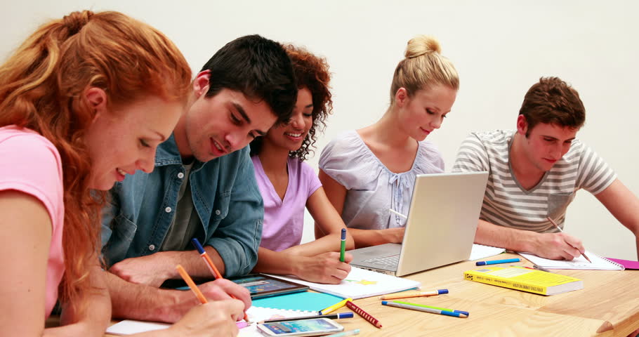 Side view of group of diverse smiling students working together on an assignment at the university | Shutterstock HD Video #5920499