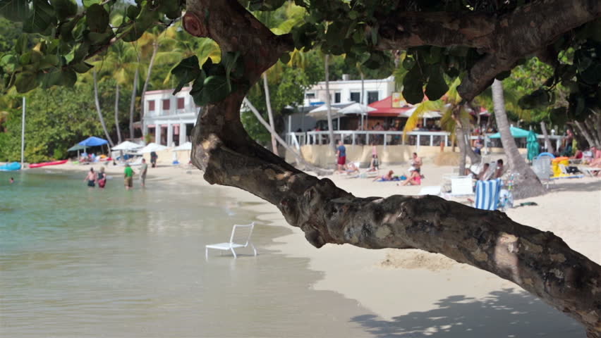 St Thomas beautiful public beach tropical. Resorts along coast beach where thousands of people come to enjoy the sun, surf, wave and warm tropical weather. Popular for families and honeymoon couples.