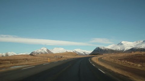 Driving toward scenic snowy mountains in Eastern Iceland