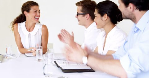 Business people applauding their boss during meeting in the office