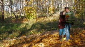 Romantic couple walking in autumn forest. Slow motion.