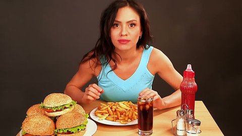 	Woman eating fast food.Time lapse