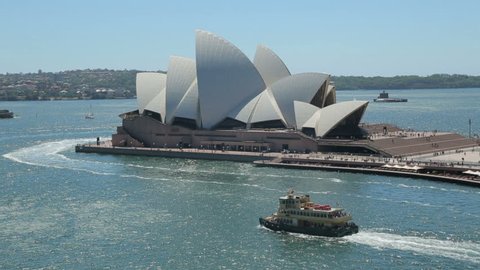 SYDNEY, AUSTRALIA - FEBRUARY 03, 2014: Sydney ferry pass Opera House.The Opera House opened in October 1973 and was designed by Jorn Utzon.
