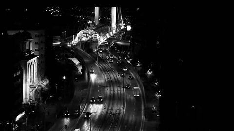 cars on the basarab bridge at night in black and white