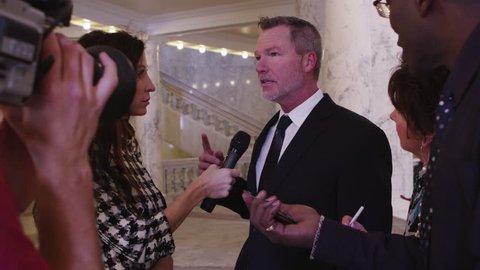 News crew interviews politician inside building - 4K