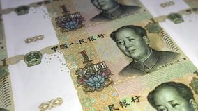 Seamless looping high definition video of 100 Chinese Yuan bills in uncut sheets being printed.  Shallow depth of field. 