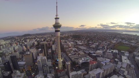 AUCKLAND ,NEW ZEALAND,- CIRCA September 2013: 300m high aerial pan of sky tower and the auckland waterfront golden sunset