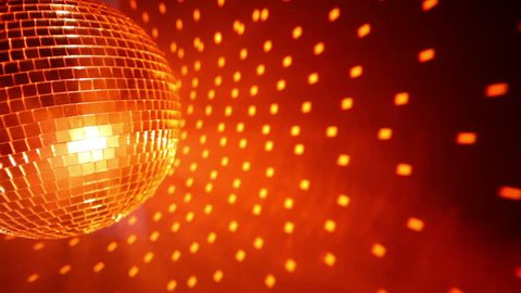 Closeup of mini disco balls under red and orange lights with a blurry  background Stock Photo by wirestock