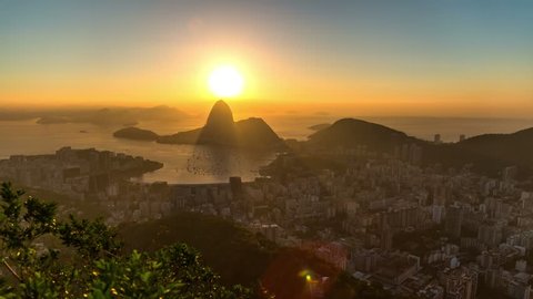 Rio De Janeiro zooming cityscape time lapse of sunrise over Sugar Loaf Mountain.