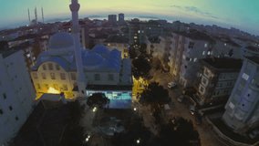 Flyover Istanbul City. Low flying over a mosque at early evening. 
aerial view.