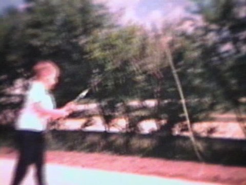 A little boy tries out his brand new fishing rod. (Vintage 8mm film)