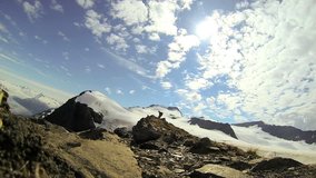 View of helicopter and Peak climber in remote wilderness Mountain Peak in snow, Troublesome Glacier, Alaska, USA - View of helicopter and Peak climber in remote wilderness, Alaska, USA