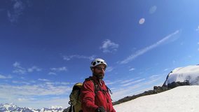 Peak Mountain climber filming snowy landscape for social media posting, Chugach Range of mountains, Troublesome Glacier, Alaska, USA - Peak climber filming snowy landscape for media posting, Alaska