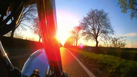 Motorcycle on the road , pov with flare