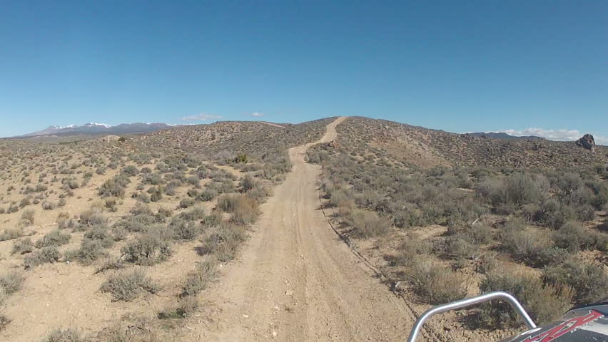Riding off road atv on desert dirt trail Utah. Riding side-by-side ATV RZR through the desert of western Utah. Fun recreation in nature. Near Little Sahara Recreation area on BLM federal owned land.