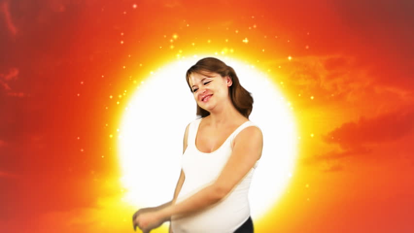 Pregnant woman dancing,sunset and sun particles
