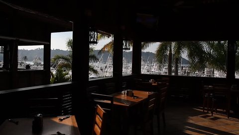 Harbor, Yachts, Boats, Dock, Resturant. The shot travels thru an empty restaurant to show a harbor in Costa Rica. 