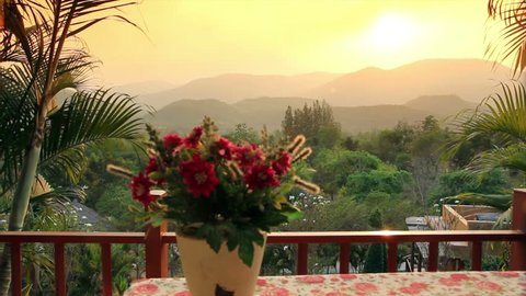Romantic of sunset among moutains in front of dinner table at home, 4K