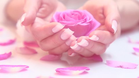Beautiful woman's nails with beautiful french manicure. Spa hands care. Beauty salon. Slow motion video footage 1080. High speed camera