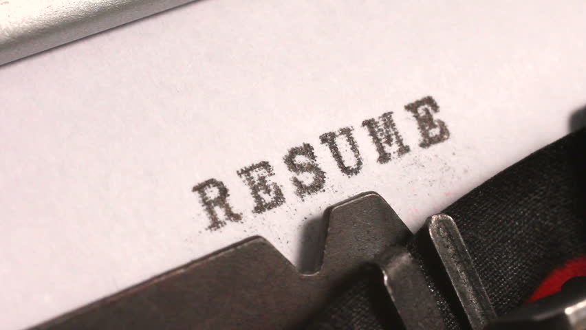Typing a Resume or Curriculum Vitae of previous experience and education for a job application on an old manual typewriter.