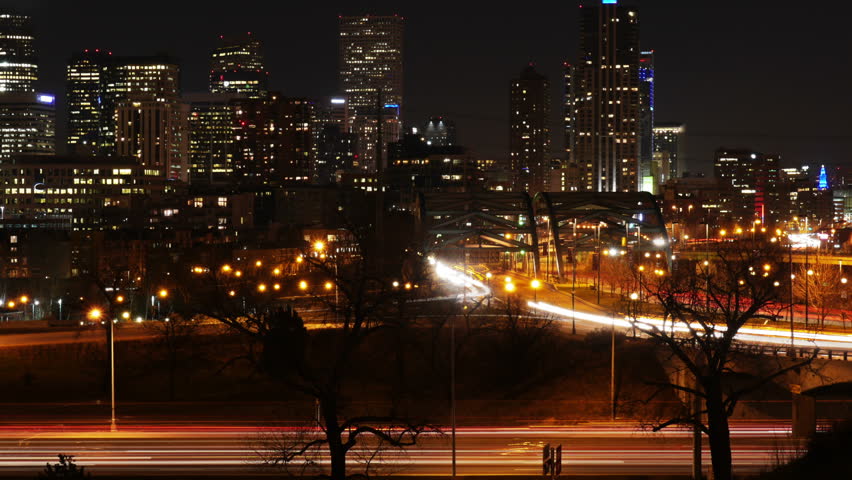 Downtown Denver, Colorado at night, with highway traffic and city skyline. Slow Zoom Out. 4K UHD. 
Ultra High Definition, 4096x2304.
