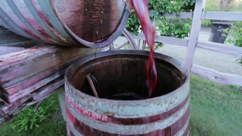 Shot of red wine falling from barrel