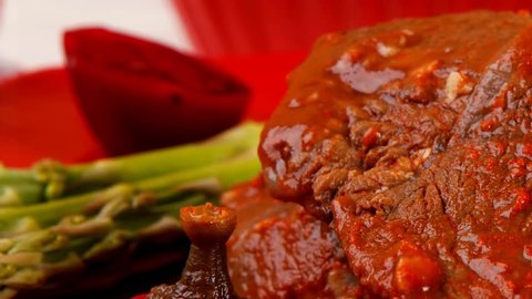 grilled beef pork meat served on red plate with asparagus hot pepper salad and bell on napkin wooden table 1920x1080 intro motion slow hidef hd