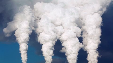 Dramatic view of smoke or steam columns from four red stacks on blue background. Dioxide carbon and warm, exhausting with the industry chimneys in atmosphere, is the great danger for global ecology.