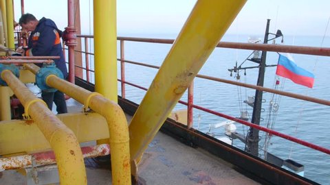 Sea of Azov, Crimea - March 28, 2014: Engineer working on offshore gas and oil production platform in the East-Kazantip field