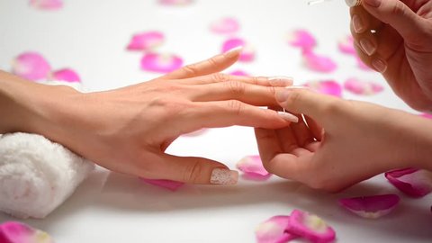 Manicure. Nail Polish. Woman in a Beauty Salon receiving a manicure by a beautician. HD video footage 