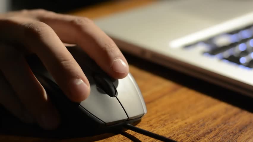 working on a notebook with a mouse