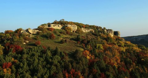 Aerial View: Flying over the Eski-Kermen plateau, near Bakhchisaray, Crimea. Autumn 2013. Eski-Kermen plateau, is a steep, 30 meter high mount which housed the eponymous cave city.