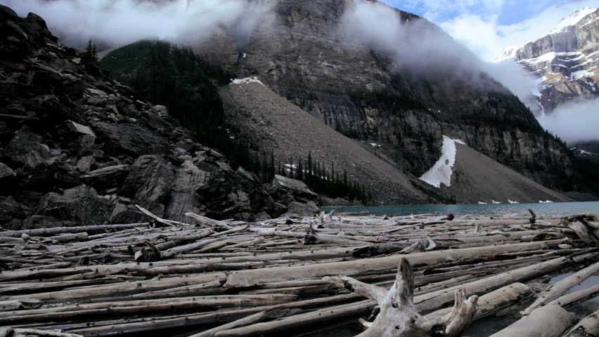 Male hiker on driftwood Lake Moraine, Banff National Park, Alberta, Canada - Male hiker Lake Moraine, Banff, Alberta, Canada