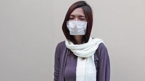sneezing sick woman with hygiene mask