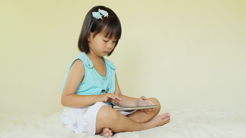 Asian young girl using computer tablet