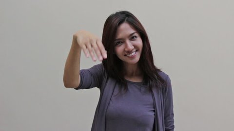 woman showing invitation or welcoming hand gesture