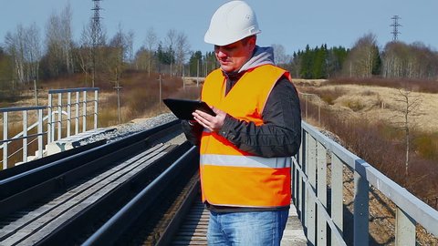 Railroad worker with tablet PC on railway